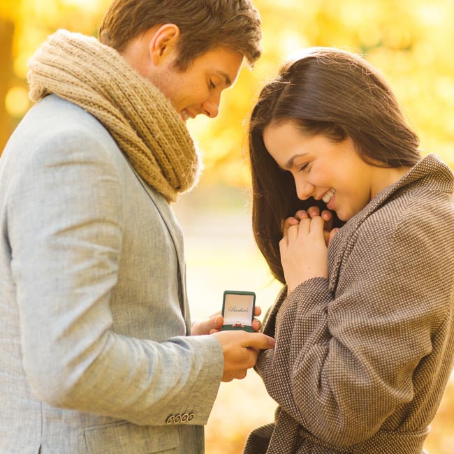 Couple Holding An Engagement Ring Box