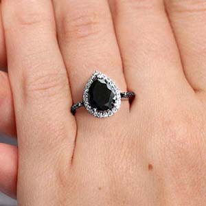 Black diamond engagement ring on a woman’s hand