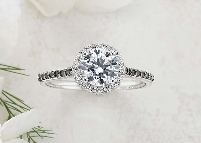 Black diamond engagement ring on stone background