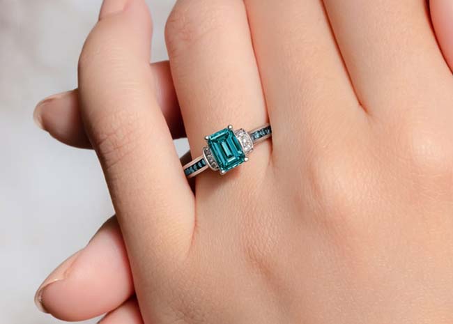 Stunning blue diamond engagement ring on a hand