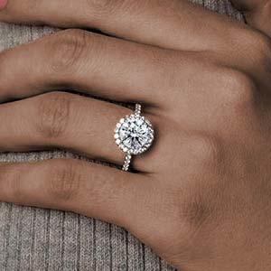 Hand with a beautiful halo engagement ring