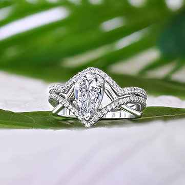 Diamond wedding set with green plants in the background
