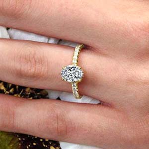 Yellow gold diamond engagement ring on a woman’s hand